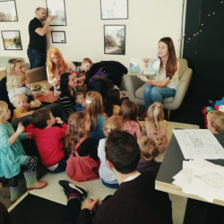 Attendes being read You Are Loved at it's launch event..